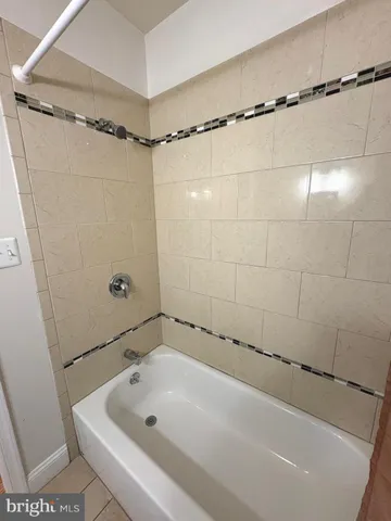 a bathroom with a tub and a shower