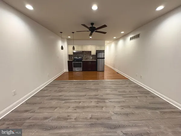a view of a kitchen with a sink and a stove top oven