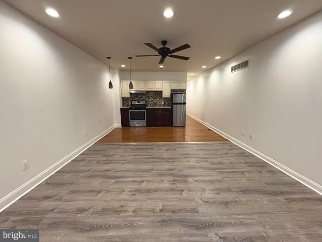 a view of a kitchen with a sink and a stove top oven