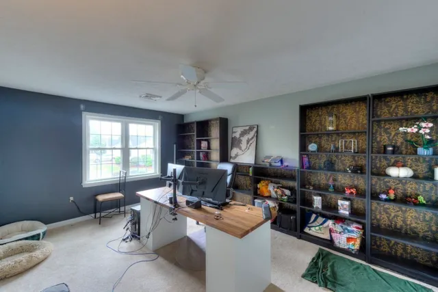 a work room with furniture and a window