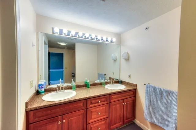 a bathroom with a double vanity sink and a mirror