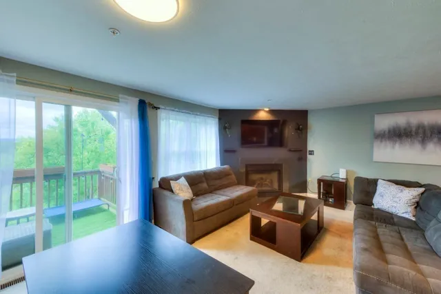 a living room with furniture and a floor to ceiling window