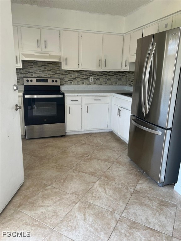 3325 Airport Road North, Unit S7 Naples, FL 34105 - Photo 3 of 7 a kitchen with granite countertop a stove a refrigerator and a sink