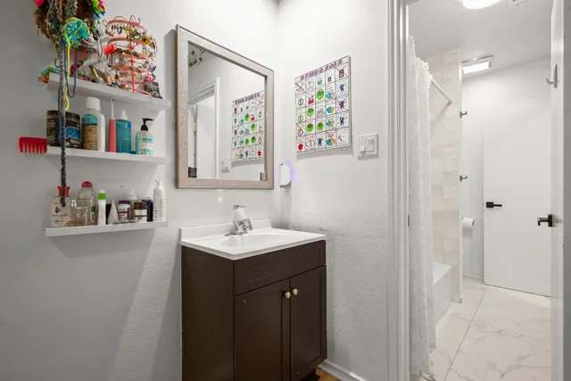 a bathroom with a sink mirror and vanity
