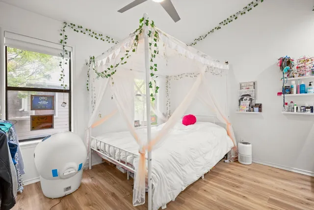 a bedroom with a bed and a window