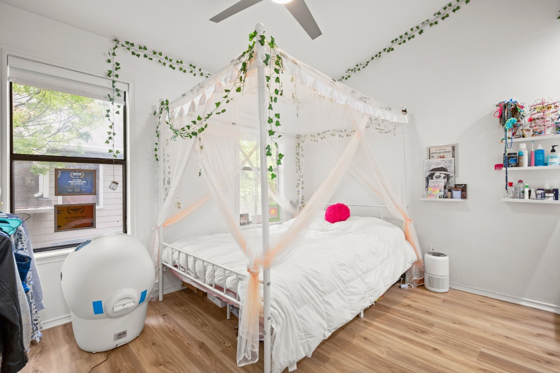 512 Eberhart Lane, Unit 1403 Austin, TX 78745 - Photo 13 of 15 a bedroom with a bed and a window