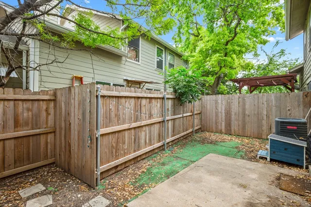 a view of a backyard with a wooden fence