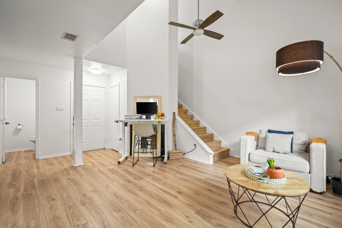 512 Eberhart Lane, Unit 1403 Austin, TX 78745 - Photo 4 of 15 a bedroom with furniture and a wooden floor