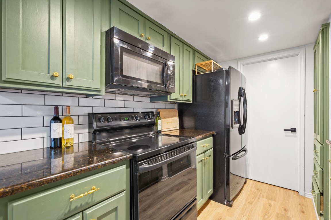 512 Eberhart Lane, Unit 1403 Austin, TX 78745 - Photo 7 of 15 a kitchen with stainless steel appliances granite countertop a refrigerator and a stove top oven
