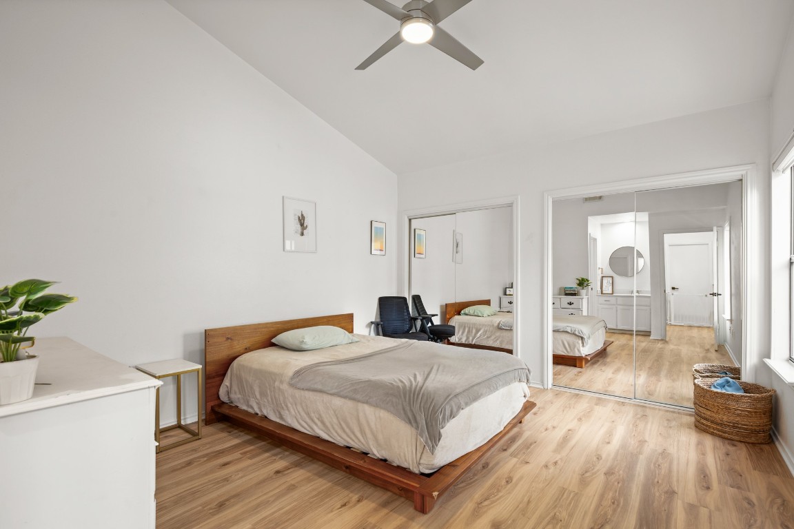 512 Eberhart Lane, Unit 1403 Austin, TX 78745 - Photo 9 of 15 a bedroom with a bed and a chandelier