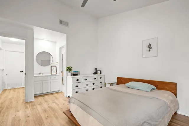 a bedroom with a bed and wooden floor