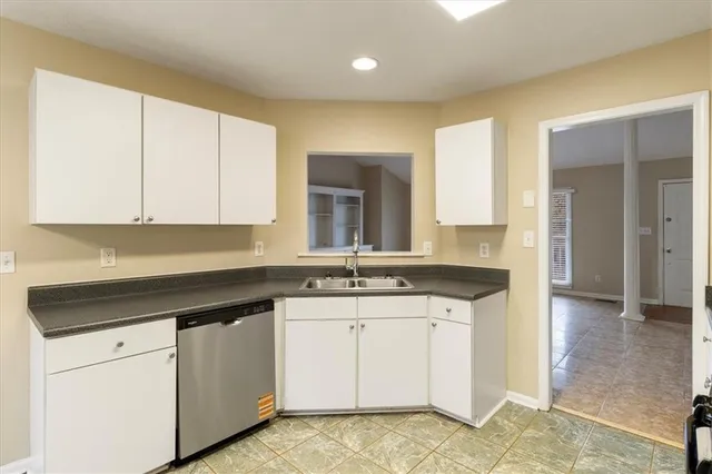 a kitchen with a sink stove and cabinets
