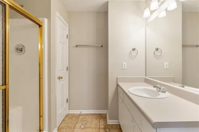 a bathroom with a tub a sink and a window