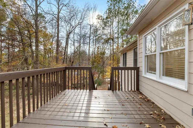 a view of a house with a wooden deck