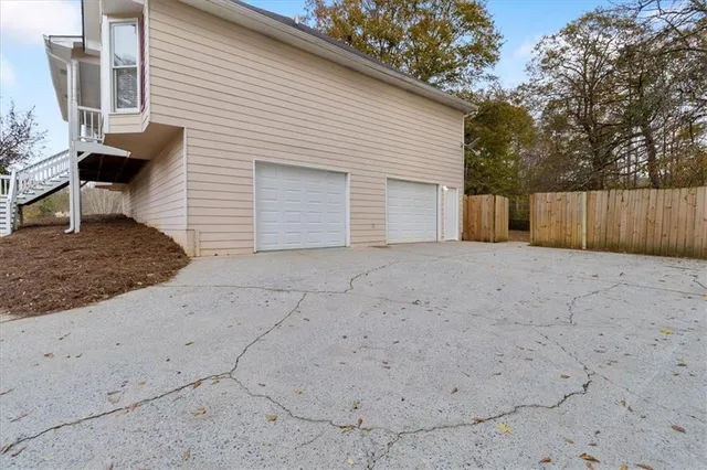 a view of a hallway with wooden floor and a bathroom