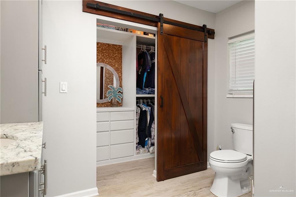 22172 North Olmito Road Rio Hondo, TX 78583 - Photo 18 of 33 a bathroom with a toilet and a shower