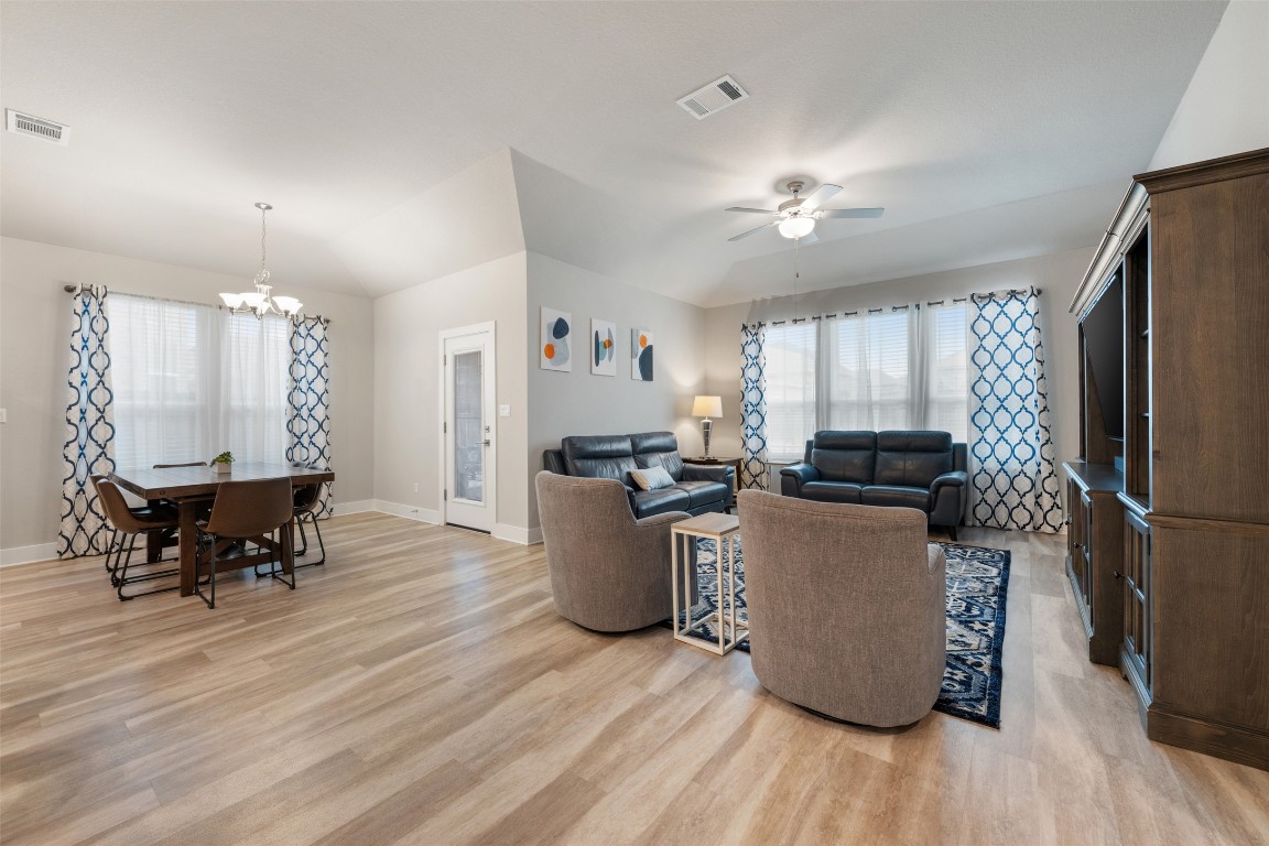 2212 Prairie Oaks Drive Georgetown, TX 78628 - Photo 11 of 39 a living room with furniture a dining table and a refrigerator