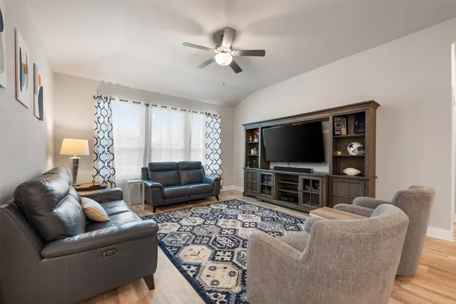 a living room with furniture and a flat screen tv