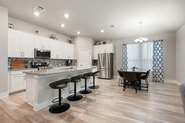 a view of kitchen with dining table and chairs