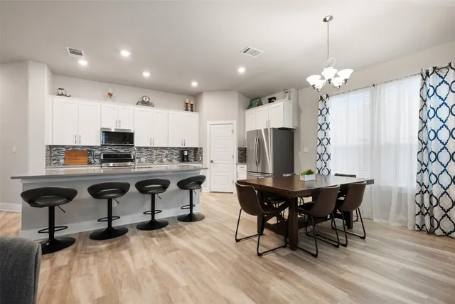 a view of a dining room with furniture wooden floor and chandelier