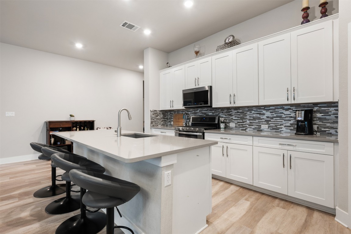2212 Prairie Oaks Drive Georgetown, TX 78628 - Photo 18 of 39 a kitchen with appliances a sink and cabinets