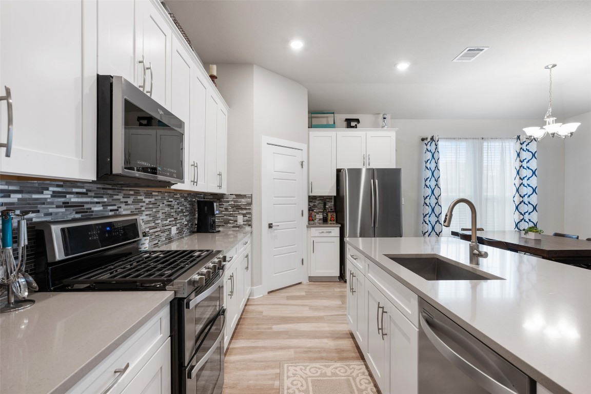 2212 Prairie Oaks Drive Georgetown, TX 78628 - Photo 20 of 39 a kitchen with stainless steel appliances a sink stove and refrigerator