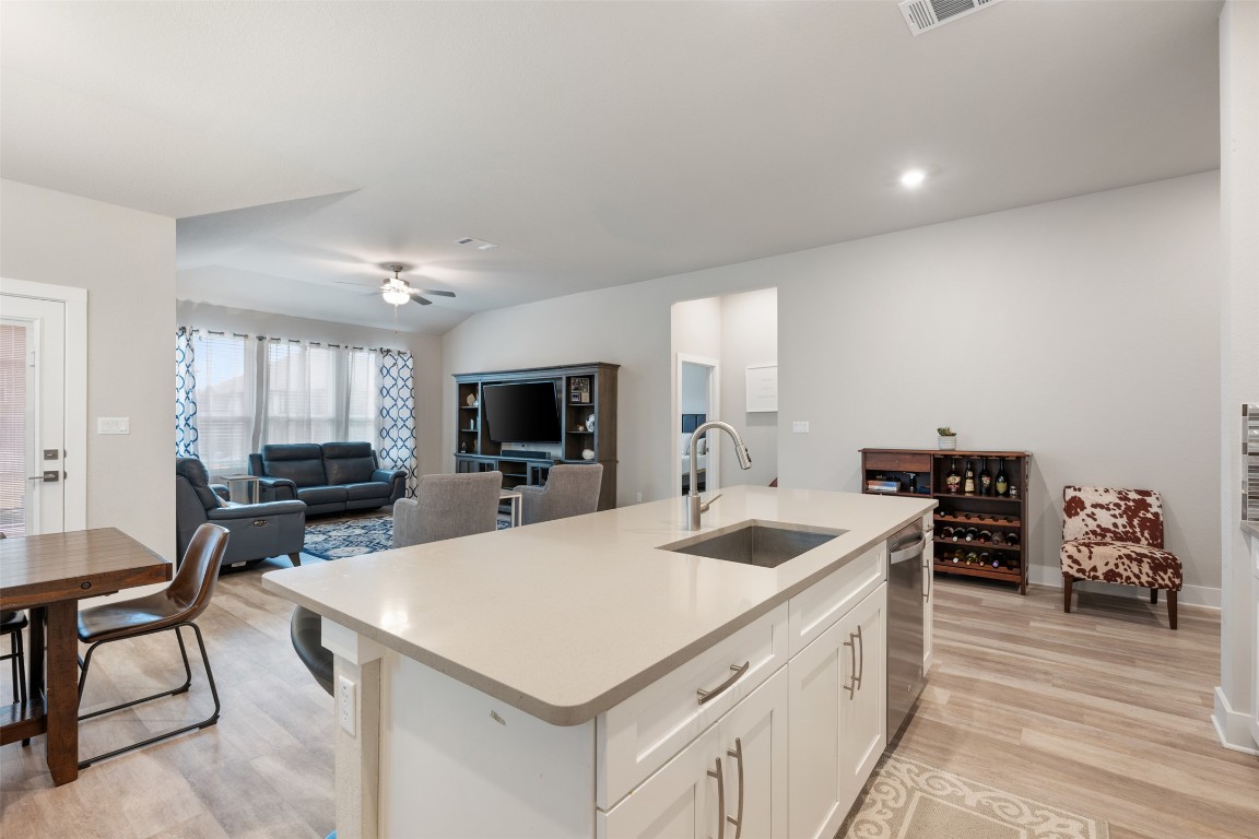 2212 Prairie Oaks Drive Georgetown, TX 78628 - Photo 21 of 39 a kitchen with a stove a sink and a refrigerator