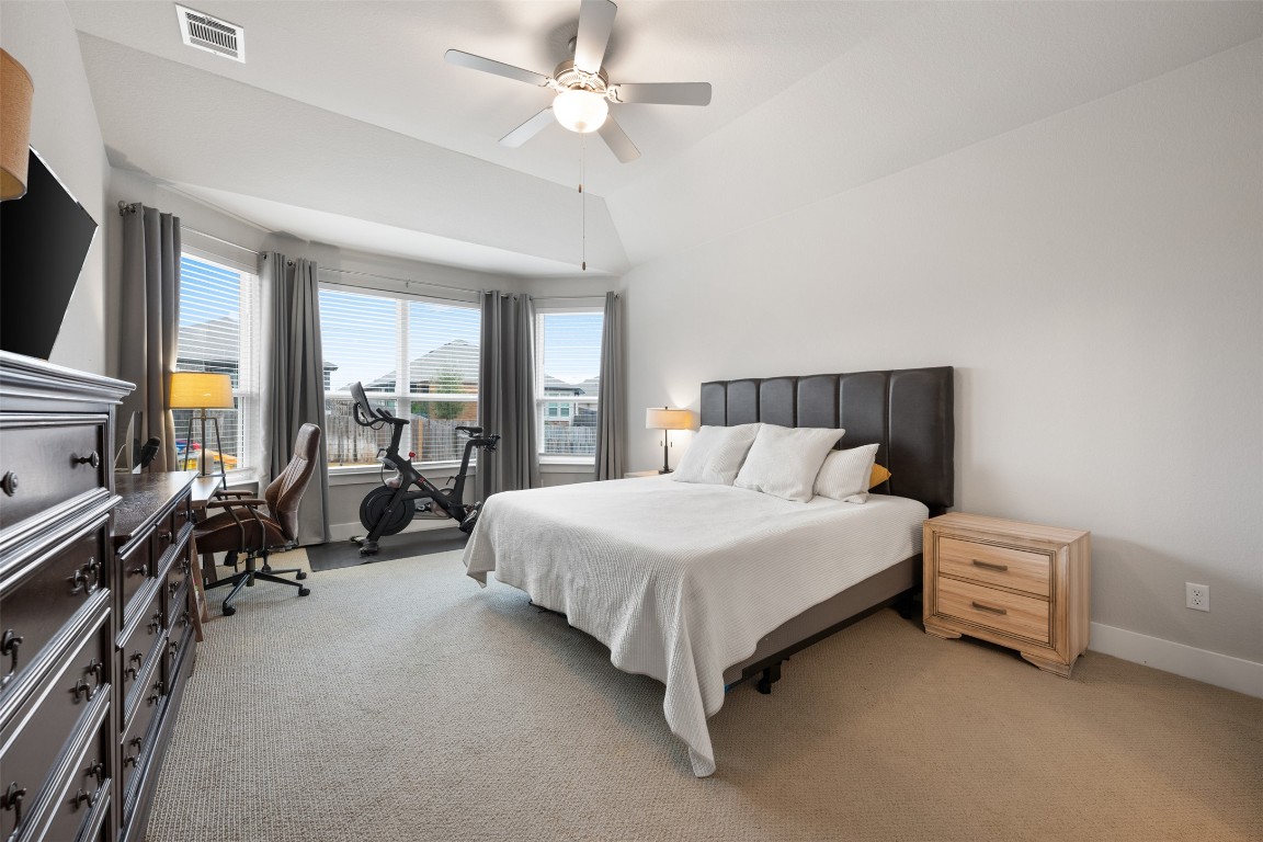 2212 Prairie Oaks Drive Georgetown, TX 78628 - Photo 23 of 39 a bed room with a bed couch and a flat tv screen