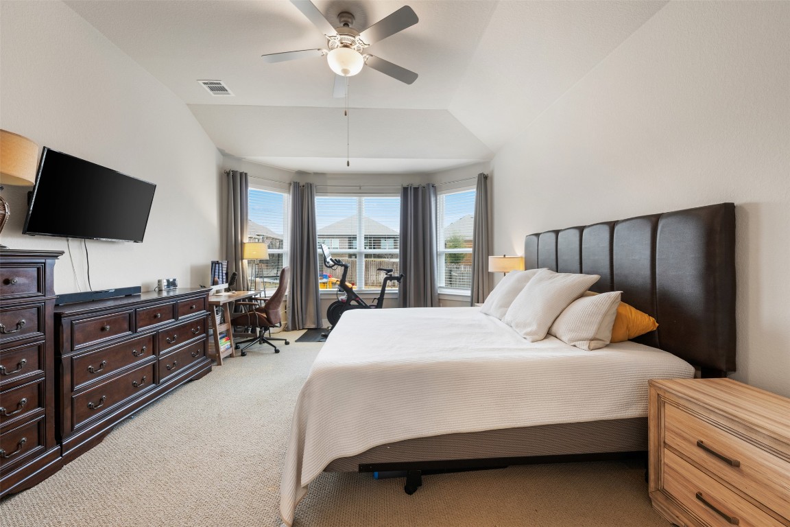2212 Prairie Oaks Drive Georgetown, TX 78628 - Photo 24 of 39 a bedroom with a bed and a flat screen tv