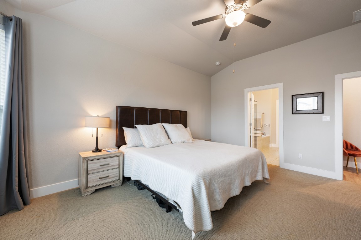 2212 Prairie Oaks Drive Georgetown, TX 78628 - Photo 25 of 39 a bedroom with a bed and a chandelier