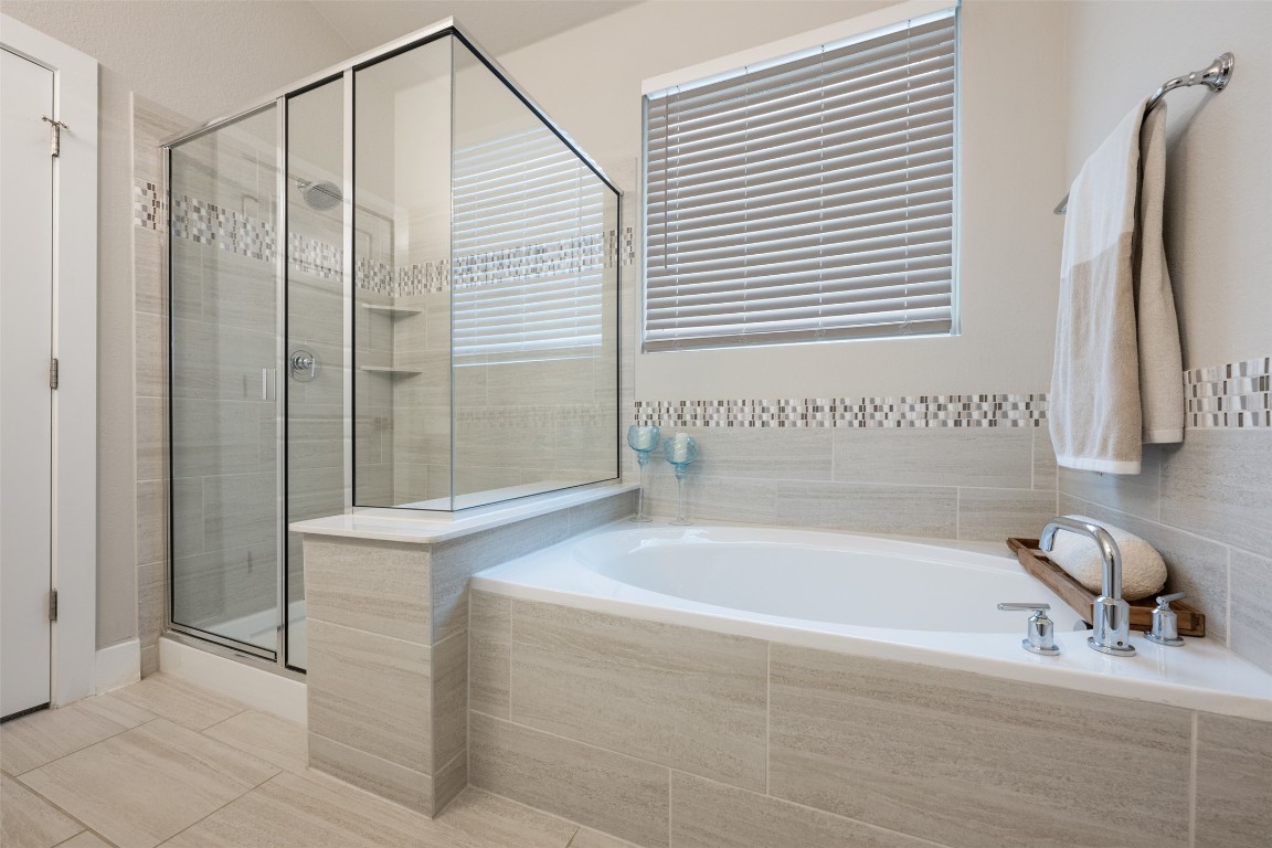 2212 Prairie Oaks Drive Georgetown, TX 78628 - Photo 28 of 39 a bathroom with a bathtub and a shower