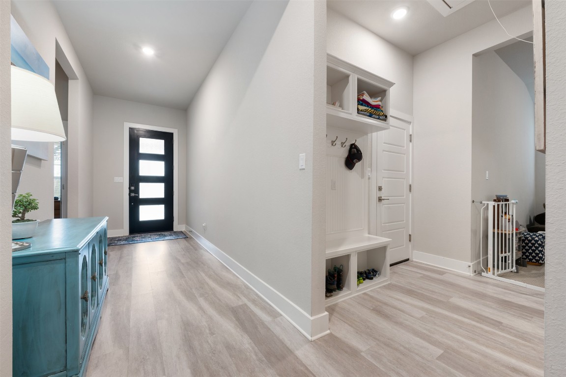 2212 Prairie Oaks Drive Georgetown, TX 78628 - Photo 29 of 39 a view of a hallway with furniture and wooden floor