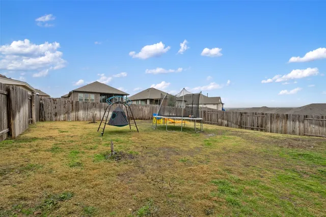 a view of a house with a backyard and a porch