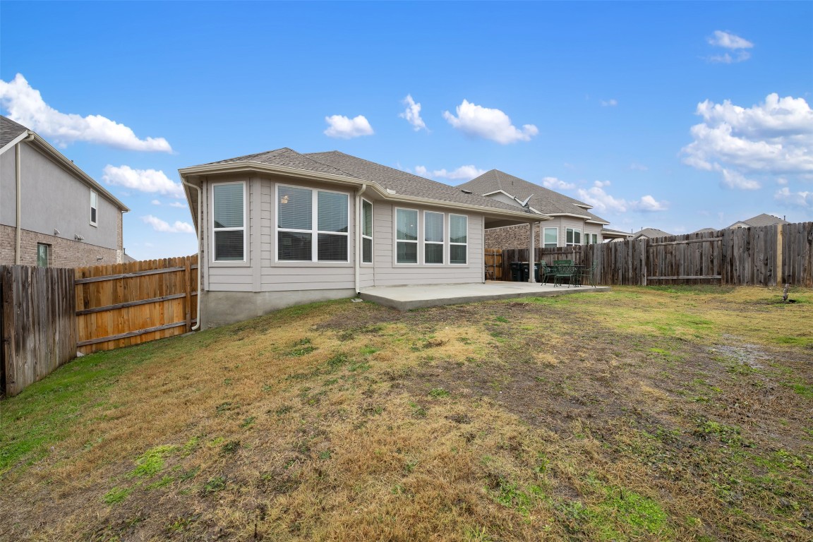 2212 Prairie Oaks Drive Georgetown, TX 78628 - Photo 37 of 39 a view of a house with wooden fence next to a yard