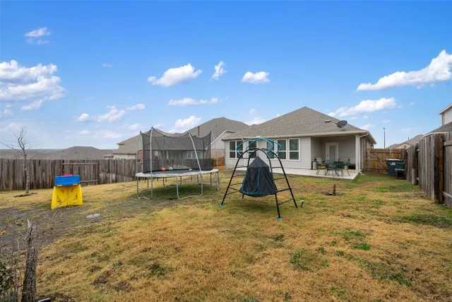 a view of a house with backyard porch and sitting area