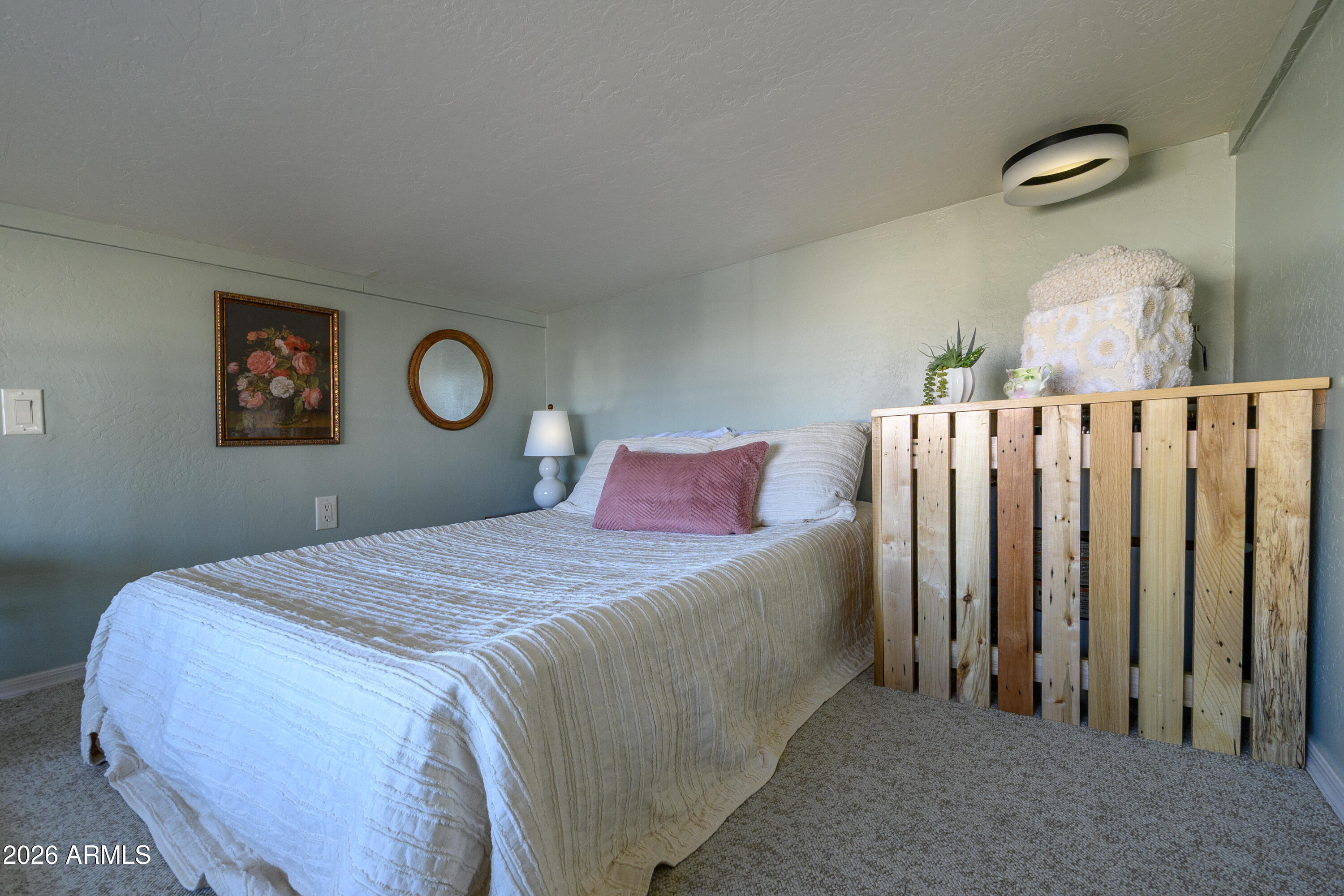 17200 West Bell Road, Unit 1052 Surprise, AZ 85374 - Photo 12 of 17 a bedroom with bed and painting on the wall