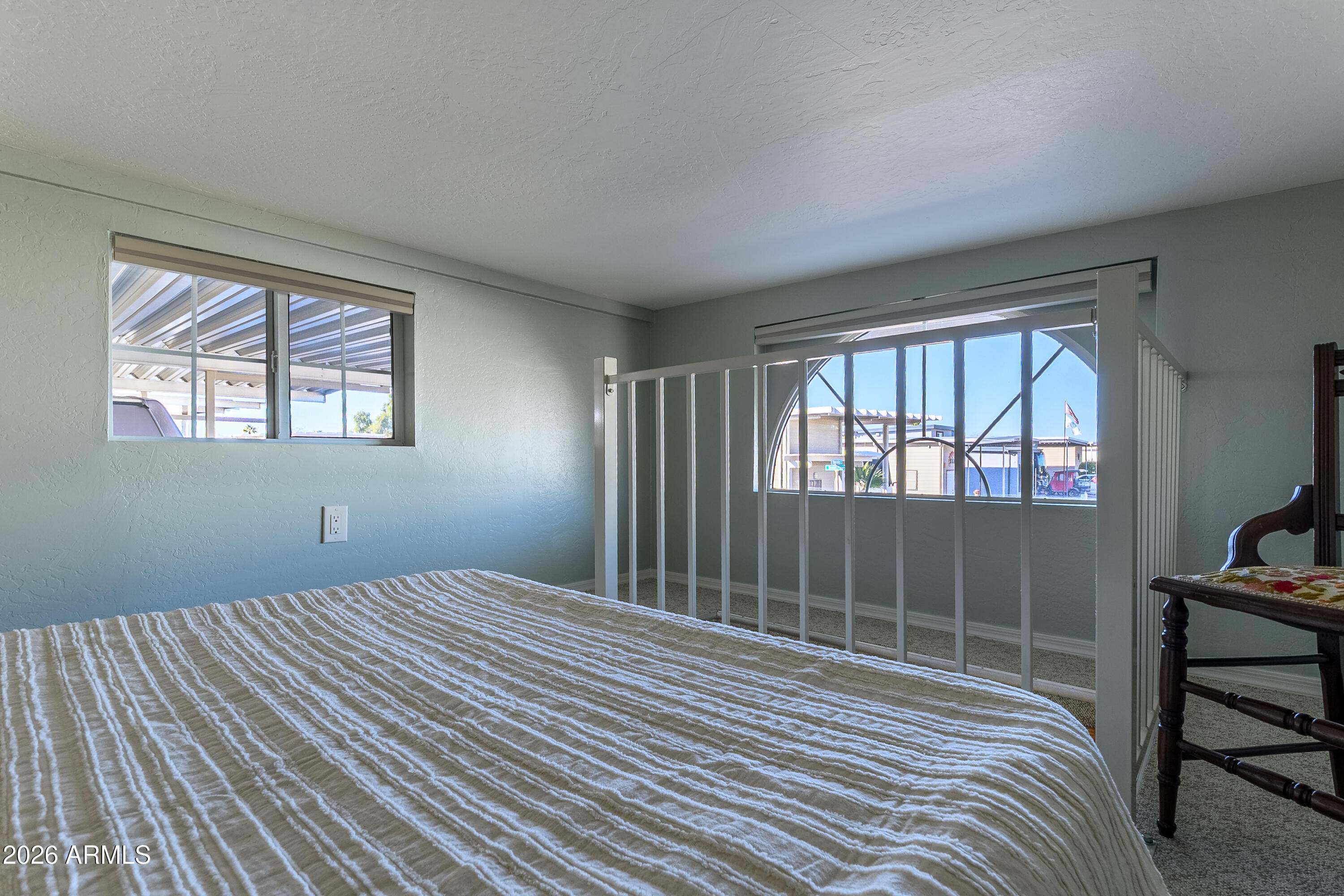17200 West Bell Road, Unit 1052 Surprise, AZ 85374 - Photo 13 of 17 a bedroom with a bed and a window