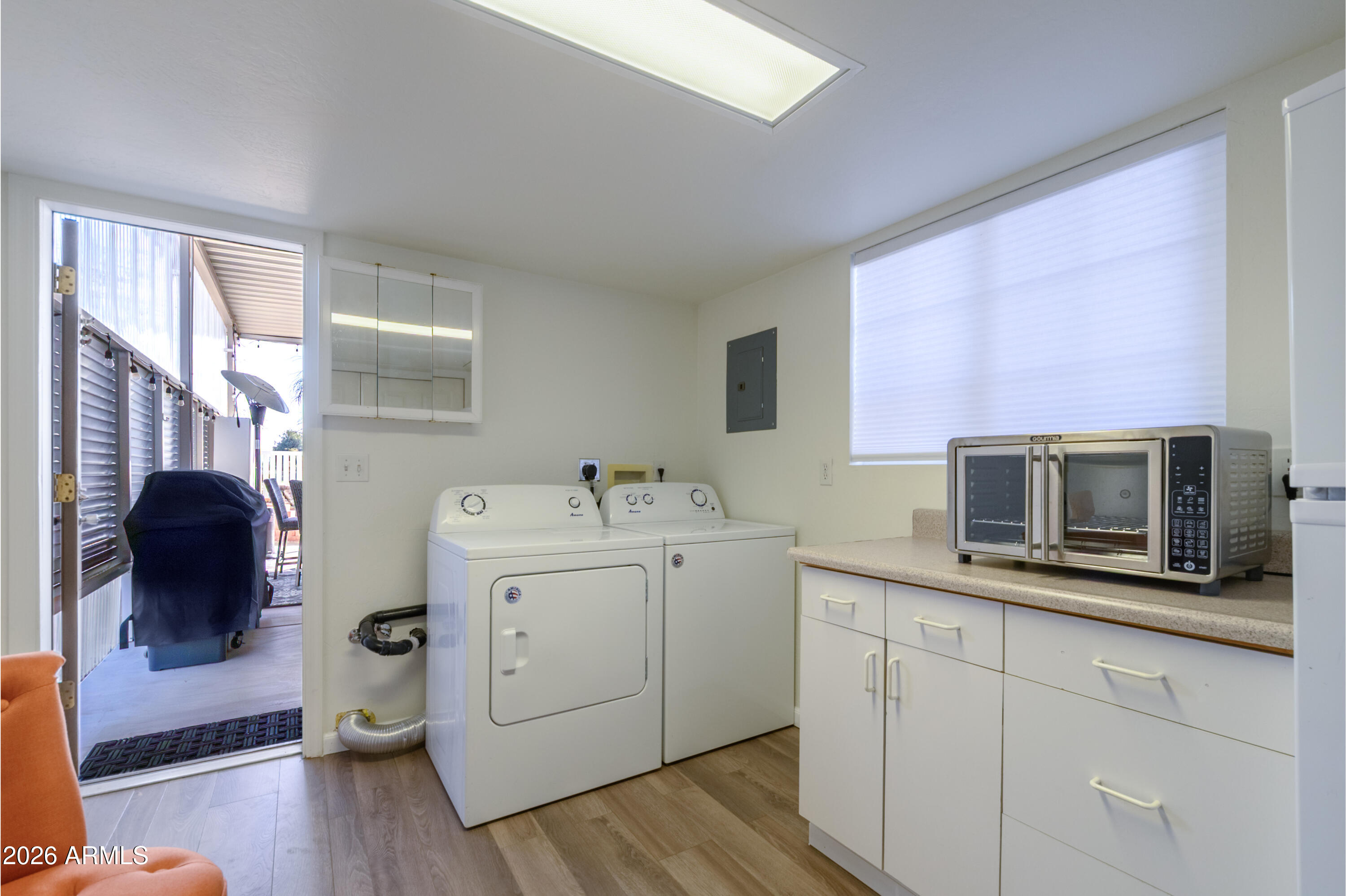 17200 West Bell Road, Unit 1052 Surprise, AZ 85374 - Photo 9 of 17 a utility room with cabinets dryer and washer