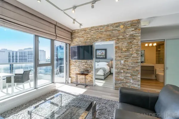 a living room with furniture and a floor to ceiling window