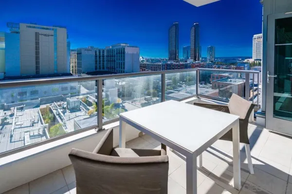 a view of a dining room with furniture a chandelier and wooden floor
