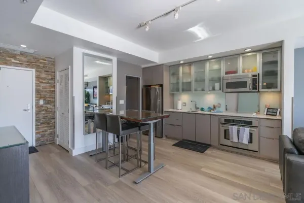 a kitchen with granite countertop a sink cabinets and wooden floor