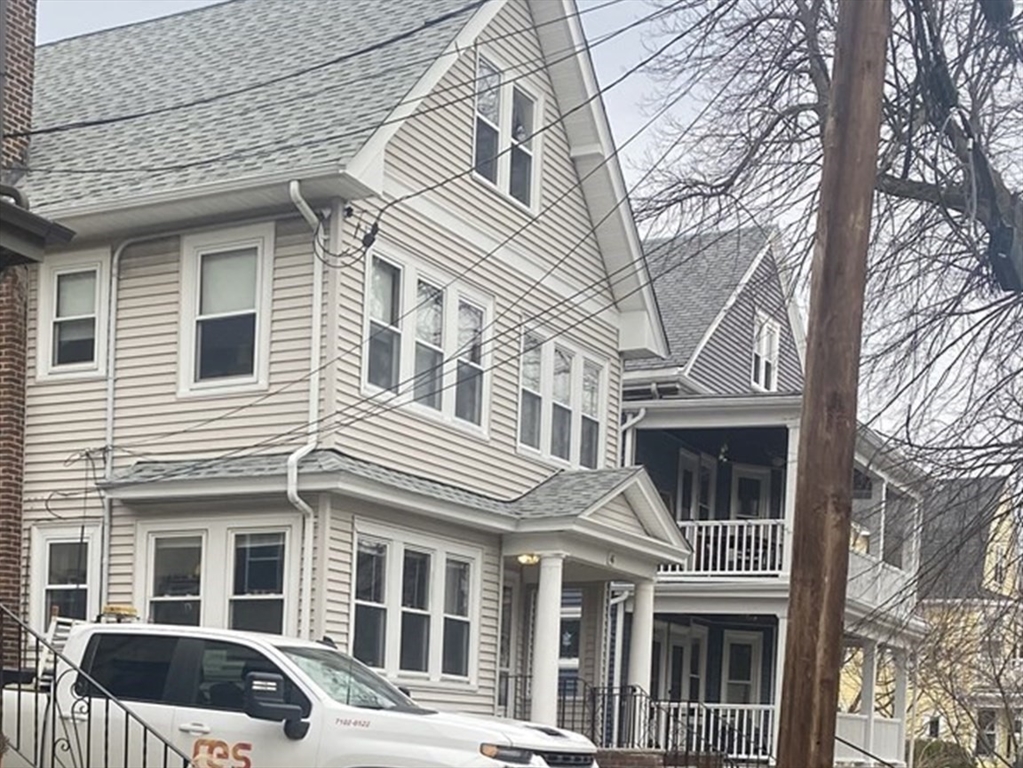 46 Grafton Street, Unit 1 Arlington, MA 02474 - Photo 12 of 12 a front view of a house with a yard