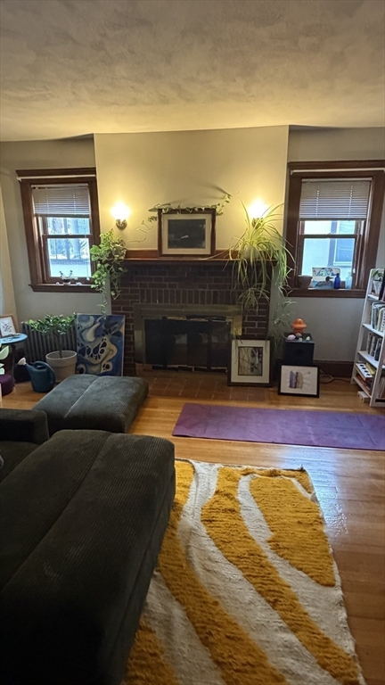46 Grafton Street, Unit 1 Arlington, MA 02474 - Photo 3 of 12 a living room with furniture and a fireplace