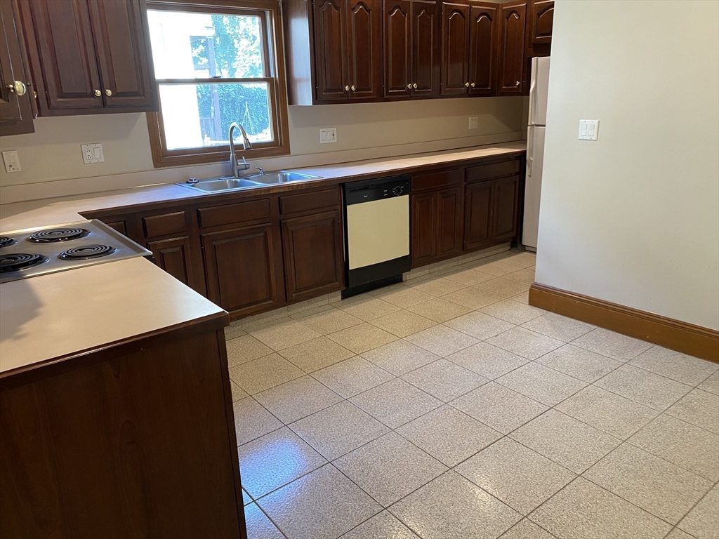 46 Grafton Street, Unit 1 Arlington, MA 02474 - Photo 6 of 12 a kitchen with a sink and cabinets