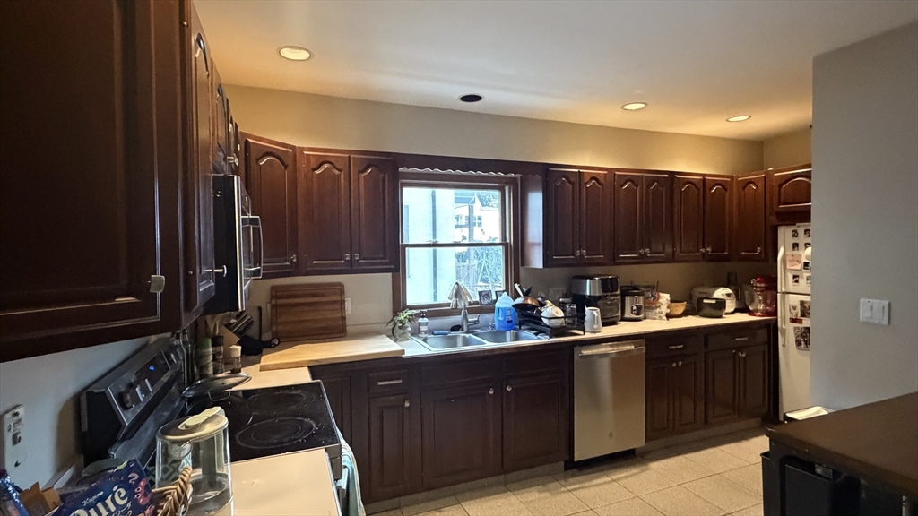 46 Grafton Street, Unit 1 Arlington, MA 02474 - Photo 7 of 12 a kitchen with sink cabinets and window