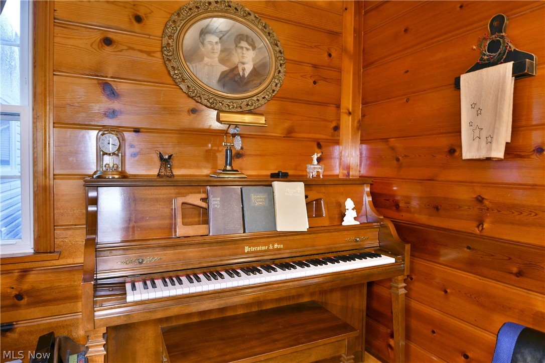 8683 King Graves Road Northeast Warren, OH 44484 - Photo 21 of 50 Interior space featuring tongue-and-groove wood paneling, a double-hung window with white trim, and a built-in wall shelf