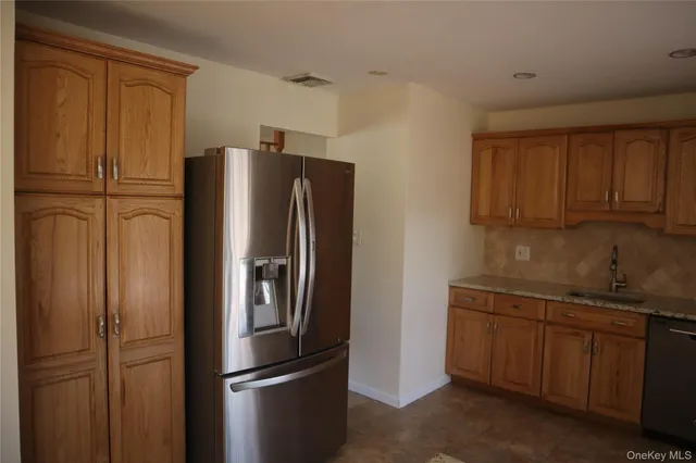 a kitchen with a sink and refrigerator