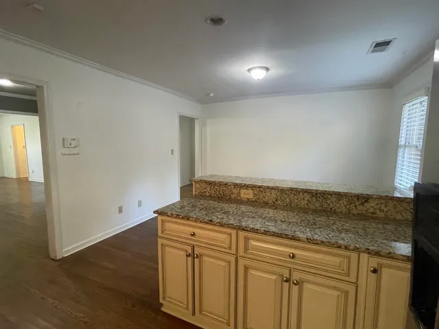 a kitchen with a refrigerator and wooden cabinets