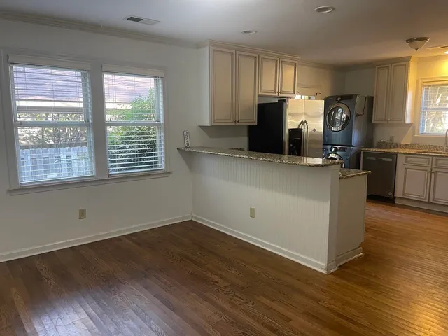 a bathroom with a granite countertop sink a mirror and a bathtub