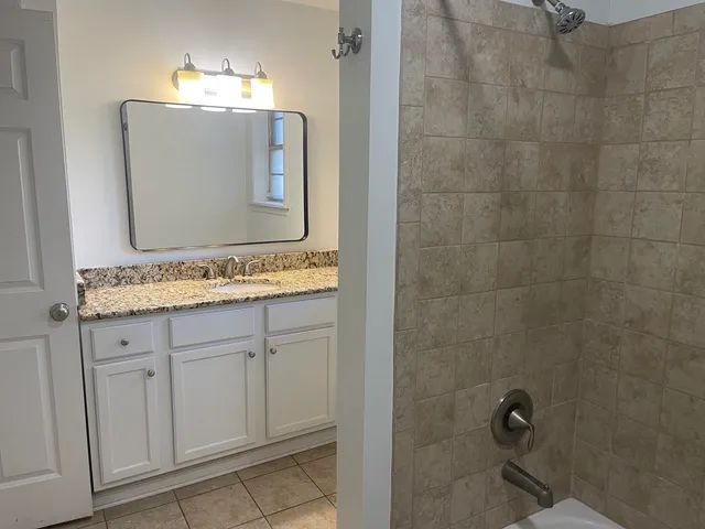 a bathroom with a bathtub a toilet and a shower